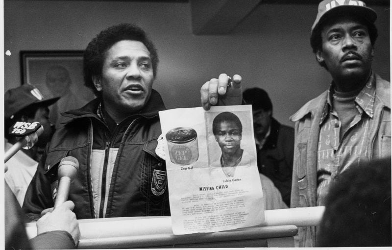 1981 -- As the Atlanta Child Murders gripped the city, Atlanta Police Chief Eldrin Bell emerged as a strong, visible figure to the frightened citizens. Here, at the West Hunter Street Baptist Church, Bell holds up a photo of Lubie (Chuck) Geter, then one of the missing children. Geter was later found dead.