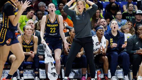 Indiana Fever guard Caitlin Clark (22) and head coach Christine Sides, center right, react after a play during the second half of an WNBA basketball game against the Dallas Wings in Arlington, Texas, Friday, May 3, 2024. (AP Photo/Michael Ainsworth)