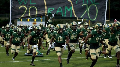 Grayson players run onto the field before their opening game against Collins Hill at Grayson High School Friday, Sept. 18, 2020, in Loganville. Grayson was ranked #1 in Class 7A, while Collins Hill was ranked #6. Grayson won 28-7. (Jason Getz/For the AJC)