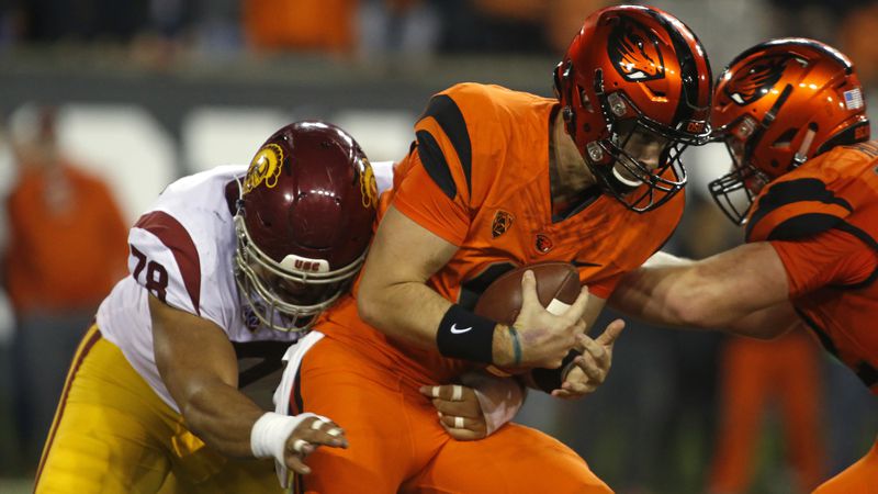 Oregon State quarterback Jake Luton (center) is sacked by Southern California's Jay Tufele (left) in the second half in Corvallis, Ore., on Saturday, Nov. 3, 2018. Southern California won 38-21. (Timothy J. Gonzalez/AP)