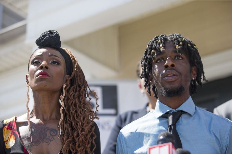 Salena Brewer (left) stands in support of her son Michael Key (right) as he speaks during a news conference at a law office in Douglasville on Monday. Attorney Tiffany Simmons is representing Key, a Morehouse College student, who alleges an employee of the college was sexually inappropriate with him. ALYSSA POINTER / ALYSSA.POINTER@AJC.COM