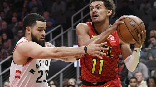 Hawks guard Trae Young (11) takes the ball into the lane as Toronto Raptors guard Fred VanVleet defends. (AP Photo/John Amis)