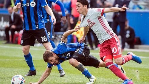 Montreal Impact’s Hernan Bernardello, front left, challenges Atlanta United’s Miguel Almiron during second-half MLS soccer game action in Montreal, Saturday, April 15, 2017. (Graham Hughes/The Canadian Press via AP)
