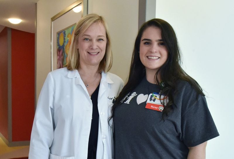 Dr. Carolyn Bennett and her former patient and now a nurse Caitlin Pirello pose for photograph at Children’s Healthcare of Atlanta’s Scottish Rite Hospital in Sandy Springs. HYOSUB SHIN / HSHIN@AJC.COM