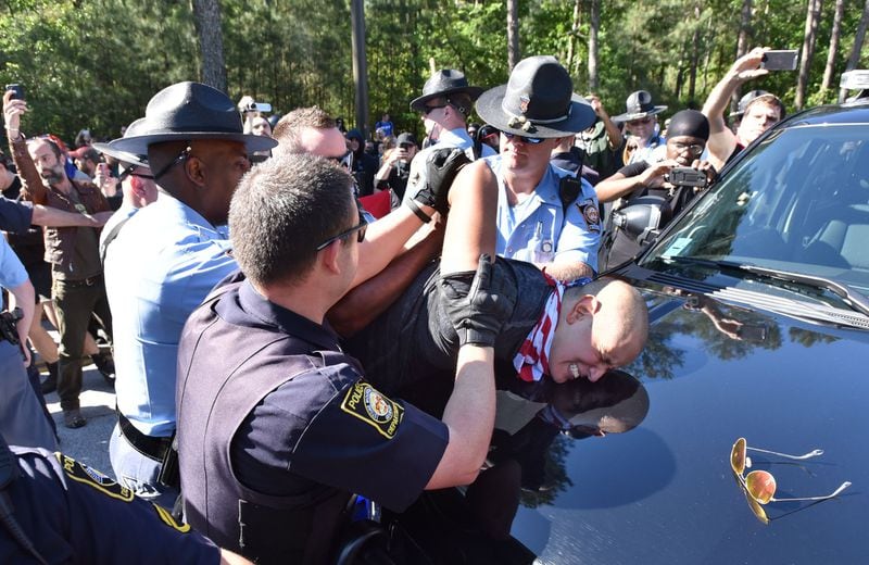 A counter-protester is arrested by police as they try to get past police and to a white power protest at Stone Mountain Park April 23, 2016. Violent protests surrounding a white power rally at Stone Mountain caused officials to shut down public attractions at the park. HYOSUB SHIN / HSHIN@AJC.COM