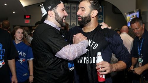 Alex Anthopoulos (left) was Toronto’s general manager in 2015 when the Blue Jays snapped a long postseason drought. He’s pictured celebrating  with Jose Bautista after a division series win against the Rangers. (Photo by Tom Szczerbowski/Getty Images)