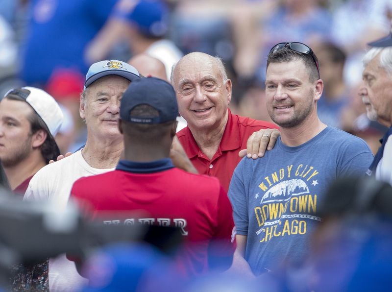 Bill Murray and Dick Vitale pose for a photo with a fan. Photo by Kyle Hess/Beam/Atlanta Braves/Getty Images