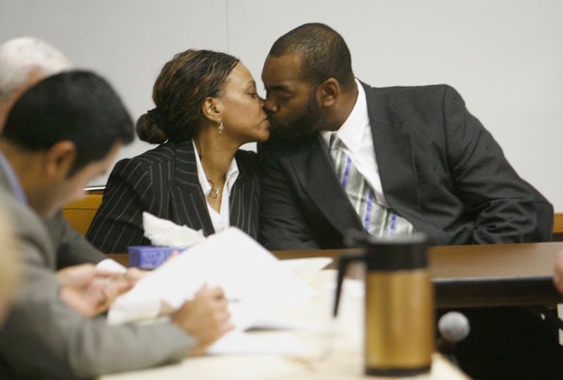Marietta, GA -- Sonya Smith (L) and husband Joseph Smith (R) share a quick kiss as the verdicts were read in their murder trial. The jury convicted the Cobb parents  on one count each of felony murder in the death of their 8-year-old son Josef. The Mableton couple displayed little emotion as the verdict was read before a Cobb County courtroom packed with supporters from a Tennessee church who paid for the Smiths' legal defense. In addition to the felony murder charge, the jury found the couple guilty on four counts each of cruelty to children in the first degree, three counts each of aggravated assault and one count each of false imprisonment and involuntary manslaughter. (Calvin Cruce / AJC staff)