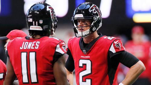 Atlanta Falcons wide receiver Julio Jones (11) and  quarterback Matt Ryan (2) confer in the huddle after they failed to connect on a pass attempt in the first half Sunday, Dec. 2, 2018, at Mercedes-Benz Stadium in Atlanta.