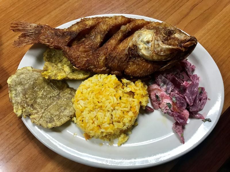 The lunch special at La Casona is an affordable way to fill up on Colombian food. Pictured is a special of whole, fried tilapia with a side of tostones (fried plantains), saffron rice and a beet salad. The lunch special also includes a cup of soup and a glass of juice. LIGAYA FIGUERAS / LFIGUERAS@AJC.COM