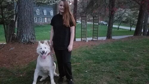 Young author Emily Rose Ross outside her east Cobb home with Balta, the family’s German Shepherd-husky rescue. Her first book, the sci-fi fantasy novel “Blue’s Prophecy,” will be released in May. CONTRIBUTED BY DIANE LORE
