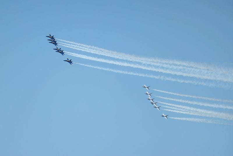 The Blue Angels, left, and the Thunderbirds fly over Atlanta Saturday to honor front-line COVID-19 responders and essential workers. (JASON GETZ/SPECIAL TO THE AJC)