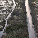 Drone photograph shows Suwannee Canal (right) and Day Use Canoe Trail (left) in the Okefenokee Swamp, Monday, Mar. 18, 2024, in Folkston. Last month, the Georgia Environmental Protection Division (EPD) released draft permits to Twin Pines Minerals for a 584-acre mine that would extract titanium and other minerals from atop the ancient sand dunes on the swamp’s eastern border, which holds water in the refuge. (Hyosub Shin / Hyosub.Shin@ajc.com)