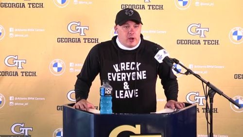 Georgia Tech coach Geoff Collins addresses media via videoconference April 13, 2021. Collins was wearing a shirt bearing the "Wreck Everyone & Leave" slogan of WWE wrestler Roman Reigns, aka Joe Anoa'i, the former Tech football captain. Collins was honoring Reigns for his Universal championship at WrestleMania 37, held Sunday.