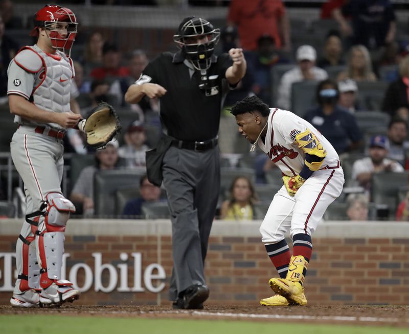 Atlanta Braves' Ronald Acuna Jr., right, reacts after being hit by a pitch thrown by Philadelphia Phillies' Sam Coonrod (not shown) in the seventh inning of a baseball game Saturday, May 8, 2021, in Atlanta. (AP Photo/Ben Margot)
