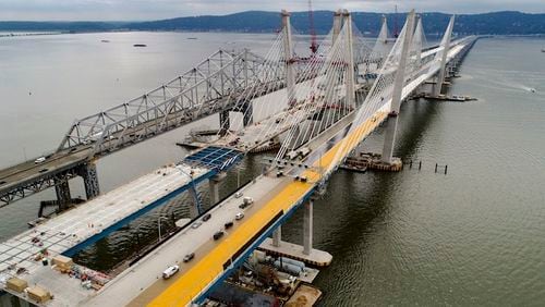 In this July 25, 2017 file photo, construction continues on the spans of the new Governor Mario M. Cuomo Bridge, right, as vehicles make their way on the the Tappan Zee Bridge over the Hudson River, near Tarrytown, N.Y. President Donald Trump's road to getting legislation through Congress this year to restore the nation's crumbling infrastructure appears increasingly precarious.  (AP Photo/Julie Jacobson, File)