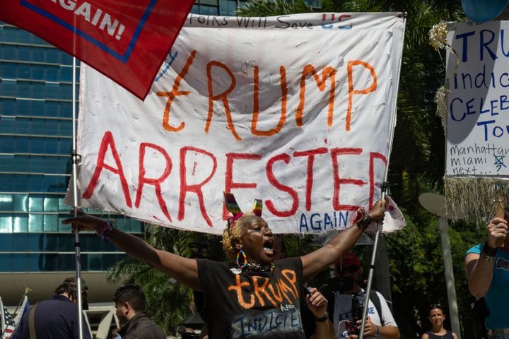 Demonstrators against former President Donald Trump  outside the Wilkie D. Ferguson Jr. U.S. Courthouse in Miami on Tuesday morning, June 13, 2023. (Christian Monterrosa/The New York Times)