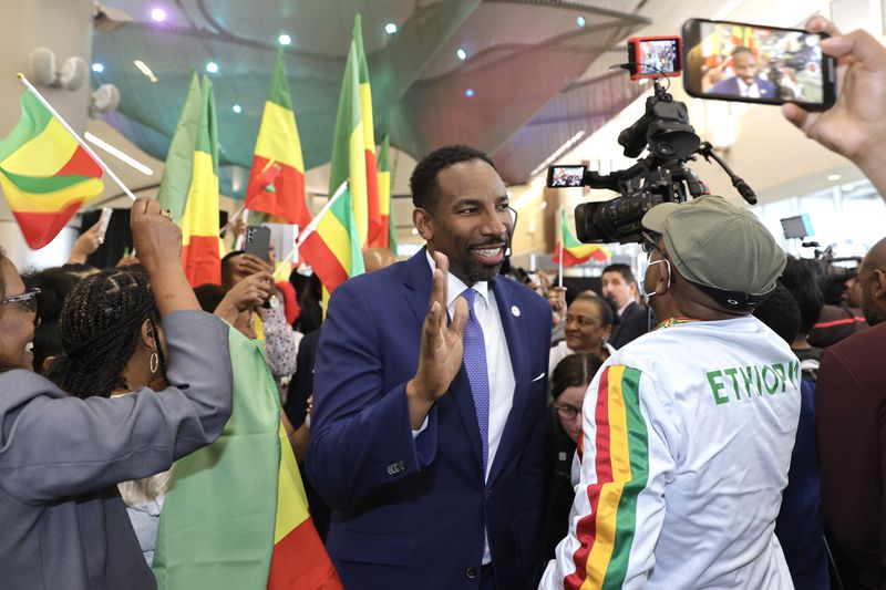Mayor Andre Dickens is welcomed by members of the Ethiopian community in Atlanta as he arrives to Maynard Jackson International Airport after the arrival of the inaugural flight of Ethiopian Airlines on Wednesday May 17, 2023.  (Natrice Miller/natrice.miller@ajc.com)
