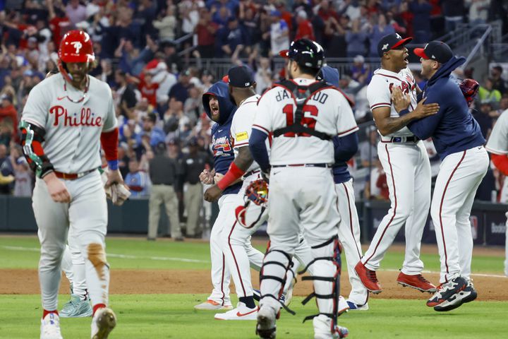 Atlanta Braves players celebrate after a double play ends the Philadelphia Phillies’ ninth inning during NLDS Game 2 in Atlanta on Monday, Oct. 9, 2023.   (Miguel Martinez / Miguel.Martinezjimenez@ajc.com)