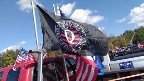 A QAnon flag flies from a truck in a pro-Trump caravan in metro Atlanta Nov. 1, 2020.