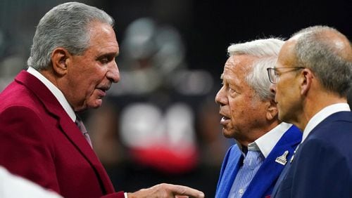 Atlanta Falcons owner Arthur Blank, left, speaks with New England Patriots owner Robert Kraft, second from right, before the first half of an NFL football game, Thursday, Nov. 18, 2021, in Atlanta. (AP Photo/Brynn Anderson)