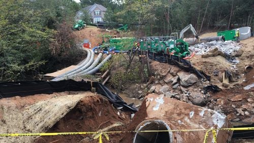 Contractors for DeKalb County were repairing large sewer pipes near Snapfinger Creek on Monday, Oct. 2, 2017. The pipes burst in August, spilling 6.4 million gallons of sewage. MARK NIESSE / MARK.NIESSE@AJC.COM