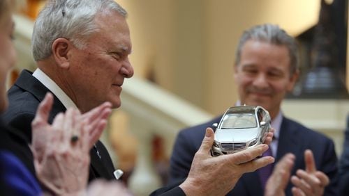 February 3, 2015 Atlanta: Gov. Nathan Deal holds a model of a Mercedes S-class car during a press conference Tuesday afternoon February 3, 2015 to announce that Mercedes-Benz USA would relocate its headquarters to Sandy Springs.