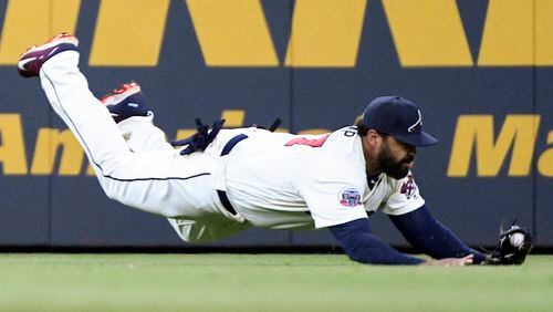 Atlanta Braves left fielder Matt Kemp makes a diving catch of a ball hit by Miami Marlins' Marcell Ozuna during the seventh inning of a baseball game, Saturday, Sept. 9, 2017, in Atlanta. (AP Photo/John Amis)