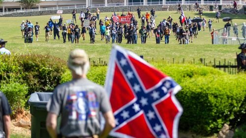 Members of the Sons of Confederate Veterans were met by counterprotesters - the two sides separated by a fence - during a rally to mark Confederate Memorial Day at Stone Mountain Park on Saturday, April 30, 2022. (Photo: Steve Schaefer / steve.schaefer@ajc.com)