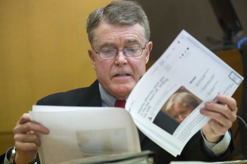 03/09/2018 -- Atlanta, GA - Charles "Bill" Crane reads a published article concerning the incident between Claud "Tex" McIver and his wife, Diane McIver, during the sixteenth day of the Tex McIver trial before Fulton County Chief Judge Robert McBurney on Monday, March 9, 2018. Bill Crane assisted Tex McIver in releasing a statement to the media shortly after the incident that left Diane McIver dead. ALYSSA POINTER/ALYSSA.POINTER@AJC.COM