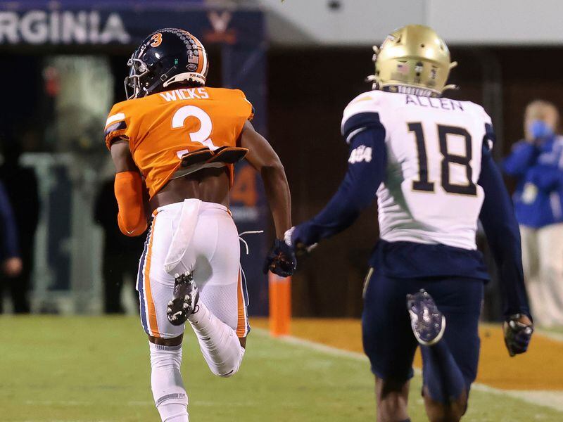 Virginia wide receiver Dontayvion Wicks (3) runs in front of Georgia Tech defensive back Derrik Allen (18) on the way to a touchdown during Saturday, Oct. 23, 2021, in Charlottesville, Va. (Andrew Shurtleff/AP)