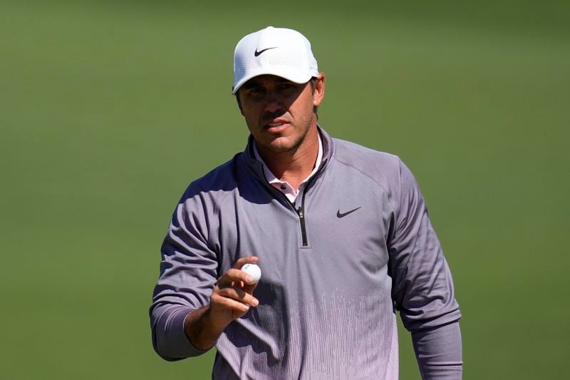 Brooks Koepka waves after making a putt on the second hole during second round at the Masters golf tournament at Augusta National Golf Club Friday, April 12, 2024, in Augusta, Ga. (AP Photo/Ashley Landis)