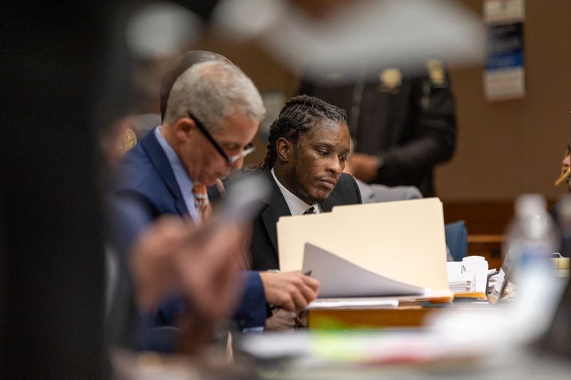 Atlanta rapper Young Thug sits with attorney Brian Steel during a hearing in Fulton County Court. The musician was one of 28 people charged in a sweeping gang indictment this year. (Arvin Temkar / arvin.temkar@ajc.com)