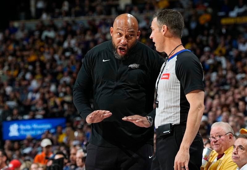 Los Angeles Lakers head coach Darvin Ham, left, argues for a call with referee Kevin Scott, front right, in the first half of Game 5 of an NBA basketball first-round playoff series against the Denver Nuggets, Monday, April 29, 2024, in Denver. (AP Photo/David Zalubowski)