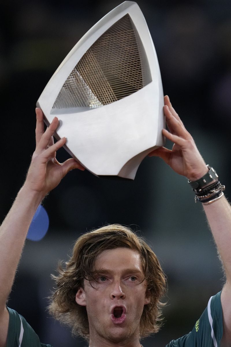 Andrey Rublev, of Russia holds his trophy after winning against Felix Auger-Aliassime, of Canada, in the Madrid Open men's final match in Madrid, Spain, Sunday, May 5, 2024. (AP Photo/Manu Fernandez)
