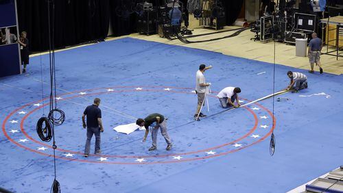 Workers install carpet as preparations continue ahead of the second presidential debate at Washington University in St. Louis, Thursday, Oct. 6, 2016. The town hall debate between Republican presidential candidate Donald Trump and Democratic presidential candidate Hillary Clinton is set for this Sunday. (AP Photo/Jeff Roberson)