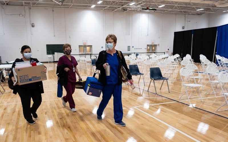 From the left, nurses Maria Rivera, Judy Spaulding and Cherie Welday head to the exit on the last day of operation for the mass vaccination site at the University of North Georgia Gainesville campus on July 30. Ben Gray for The Atlanta Journal-Constitution