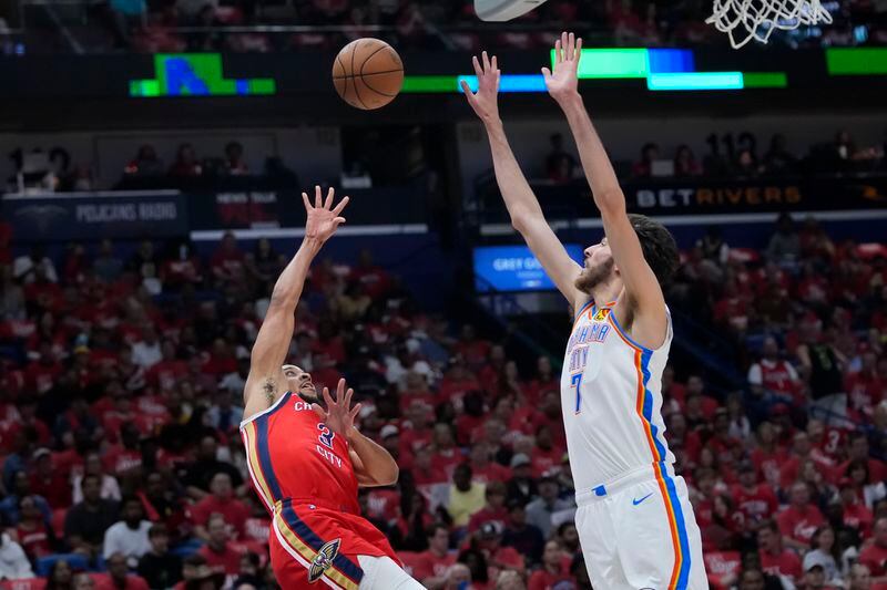 New Orleans Pelicans guard CJ McCollum (3) shoots against Oklahoma City Thunder forward Chet Holmgren (7) in the first half of Game 3 of an NBA basketball first-round playoff series in New Orleans, Saturday, April 27, 2024. (AP Photo/Gerald Herbert)