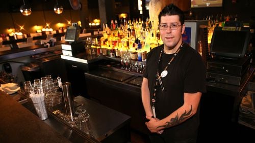 Kevin Colpo, 33, a bartender at Dave & Busters, at the Marietta location. Colpo has been working there for two years and makes $8.50 an hour plus tips. The service and hospitality sectors have seen strong growth since the recession. (HENRY TAYLOR / HENRY.TAYLOR@AJC.COM)