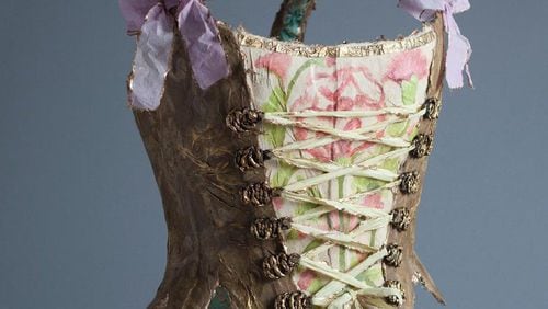“Lady Plum Corset” in paper, 24K gold leaf, watercolor, Swarovski crystals and copper by Fabiola Jean-Louis appears at Alan Avery Art Company.