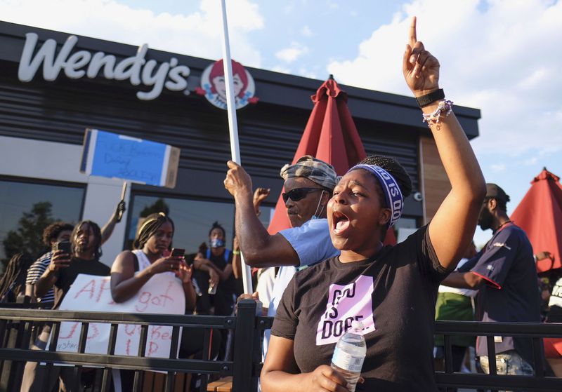 Protesters gather on Saturday evening at the Atlanta Wendy's where Rayshard Brooks, a 27-year-old black man,  was shot and killed by Atlanta police the night before during a struggle in the drive-thru line.    Ben Gray for the Atlanta Journal Constitution