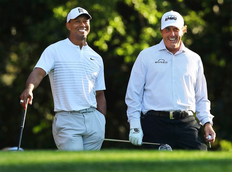 Tiger Woods and Phil Mickelson laugh it up during a practice round at the Masters. (Curtis Compton/Atlanta Journal-Constitution via AP, File)