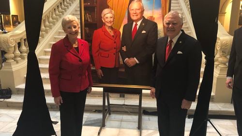 Sandra Deal and Gov. Nathan Deal pose by an official portrait unveiled at the Georgia Capitol. AJC/Greg Bluestein