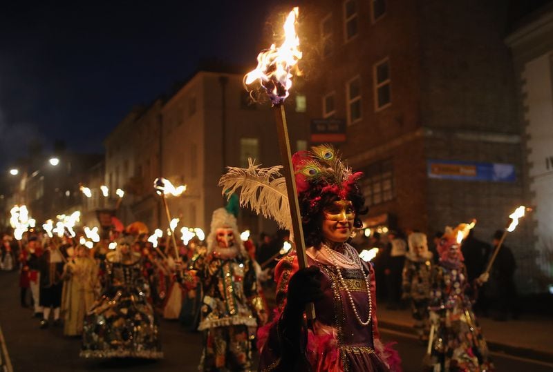 LEWES, ENGLAND - NOVEMBER 05:  Members of the Pheonix Bonfre society walk with burning staffs during the Bonfire Night celebrations on November 5, 2012 in Lewes, Sussex in England. Bonfire Night is related to the ancient festival of Samhain, the Celtic New Year. Processions held across the South of England culminate in Lewes on November 5, commemorating the memory of the seventeen Protestant martyrs. Thousands of people attend the parade as Bonfire Societies parade through the narrow streets until the evening comes to an end with the burning of an effigy, or 'guy,' usually representing Guy Fawkes, who died in 1605 after an unsuccessful attempt to blow up The Houses of Parliament.  (Photo by Dan Kitwood/Getty Images)
