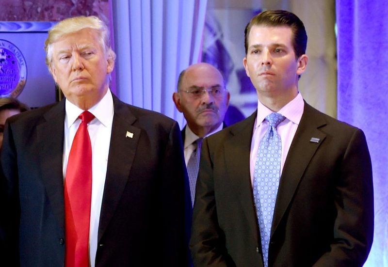 Then President-elect Donald Trump along with his son Donald, Jr., arrive for a news conference at Trump Tower in New York, as Allen Weisselberg, center, chief financial officer of The Trump Organization, looks on Jan. 11, 2017. Republican candidates are heading to Florida for a fundraising summit and Trump is expected to speak. (Timothy A. Clary/AFP via Getty Images/TNS)