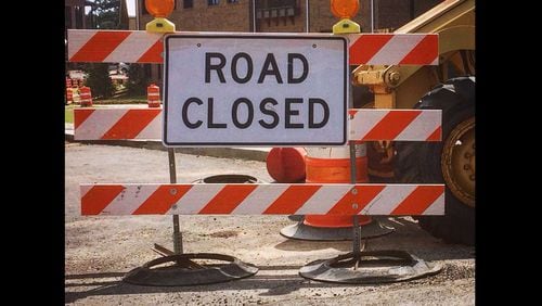 A "road closed" sign blocks the entrance to a street in north Fulton County.