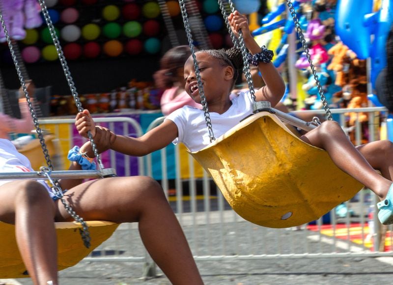 People enjoy the rides at the Atlanta Fair near the old Turner Field on Sunday, March 6, 2022. This was the opening weekend for the annual fair that runs through April 10. (Photo by Steve Schaefer for The Atlanta Journal-Constitution)