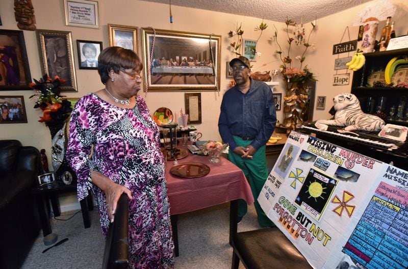 Catherine Leach-Bell (left) and Larry Bell show a board they made to appeal their son’s murder case, which happened in 1981 during the Atlanta Child Murders period, at their apartment home in Atlanta on Friday, December 8, 2017. HYOSUB SHIN / HSHIN@AJC.COM