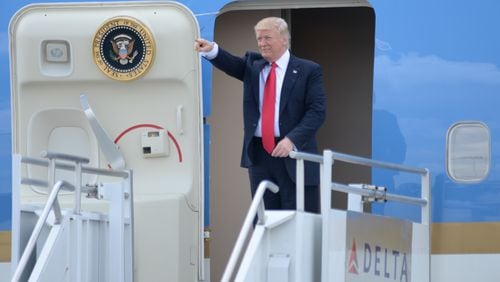 President Donald Trump waves at a crowd of people waiting as he arrives at Hartsfield Jackson International Airport, aboard Air Force One, Friday April 28, 2017. KENT D. JOHNSON/ kdjohnson@ajc.com