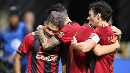 Atlanta United team mates congratulate Atlanta United forward Josef Martinez (7) after he scored a goal in the first half, including Michael Parkhurst (right).  The Atlanta United soccer team plays the Portland Timbers for the MLS Cup, the championship game of the Major League Soccer League at Mercedes-Benz Stadium in Atlanta.   CURTIS COMPTON / CCOMPTON@AJC.COM